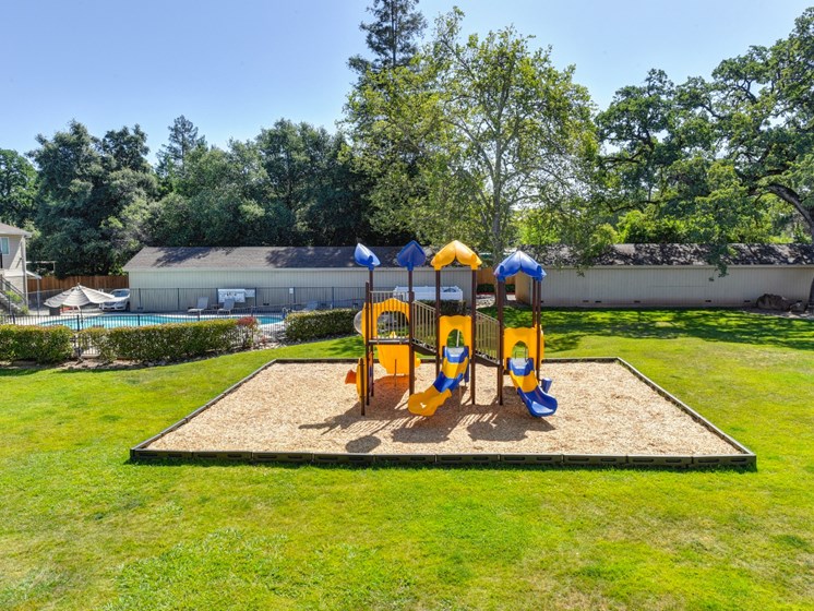 Playground with Sand, Grass and Apartment Exteriors